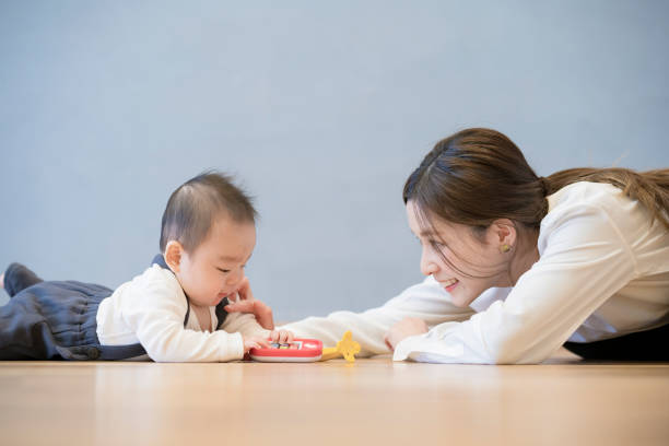 istock Mom playing with baby indoors 1305235485
