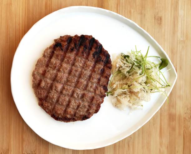 istock pleskavitsa cutlet and fresh vegetable salad on a white plate. 1305236197