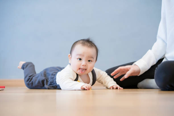 istock Baby crawling on the floor 1305236369