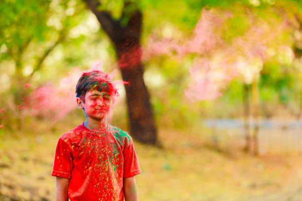 istock Holi celebrations -Indian little boy playing Holi and showing face expression. 1305238392