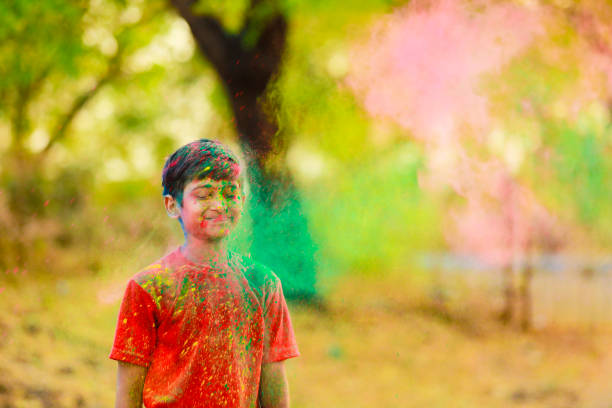 istock Holi celebrations -Indian little boy playing Holi and showing face expression. 1305238418