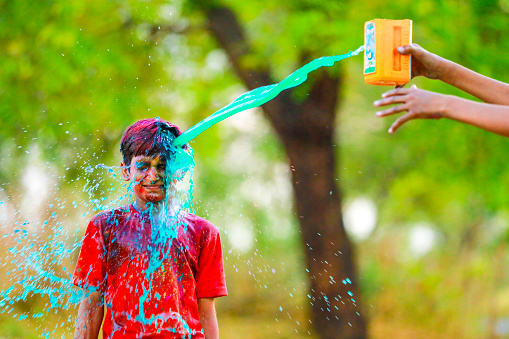 Holi celebrations - Splash of colorful water on Holi festival.