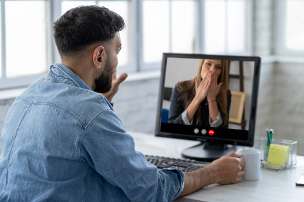istock Back view of male speaking on video call with his girlfriend 1305242162