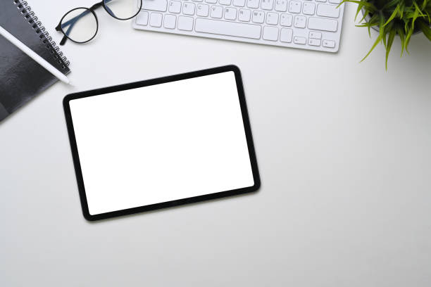 istock Above view of digital tablet with empty screen on white office desk. 1305242840