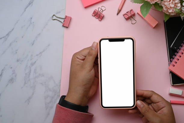 istock Mock up mart phone with blank screen on pink and marble background. 1305242856