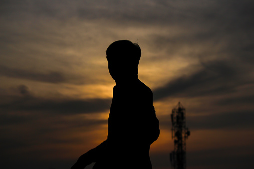 A silhouette of a person in sunset