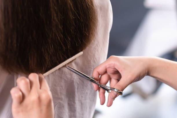 istock hair stylist trimming client hair by scissors 1305246073