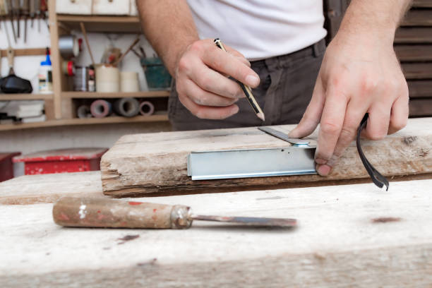 istock Male carpenter working with wood material in a garage. 1305247892
