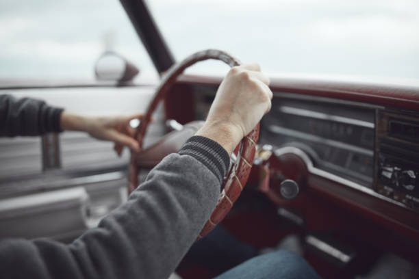 Man in retro clothes driving vintage American car.