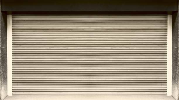 istock Closed steel shutter door of warehouse, storage or storefront for background and textured. 1305247946