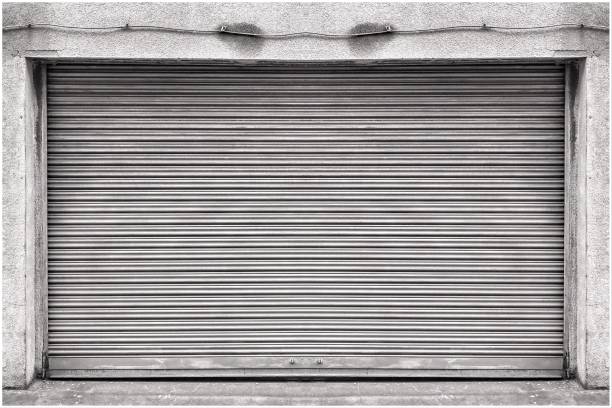 Closed steel shutter door of warehouse, storage or storefront for background and textured.