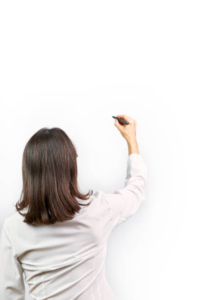 istock Executive woman writing with a black marker pen on a white background 1305248231