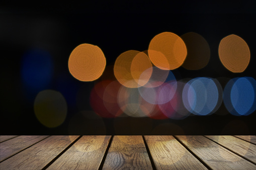 Empty wood table top and blur of night Restaurant bokeh background.