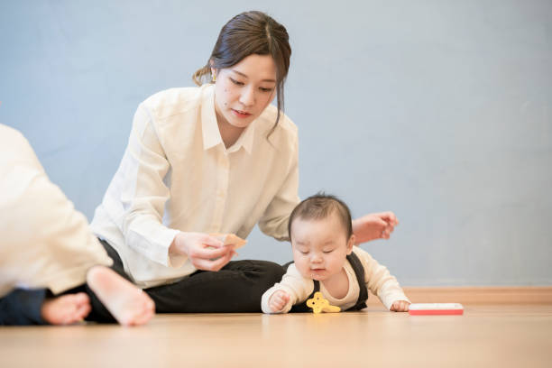 istock Mom playing with baby indoors 1305253474