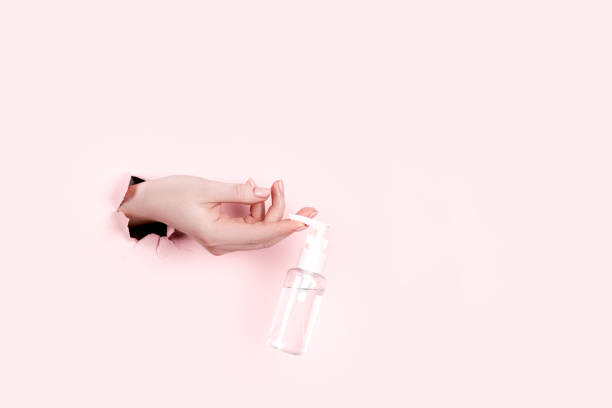 istock Female hand holding hyaluronic bottle from torn paper 1305253731