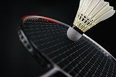 Close-up a badminton player hitting a badminton ball in a match