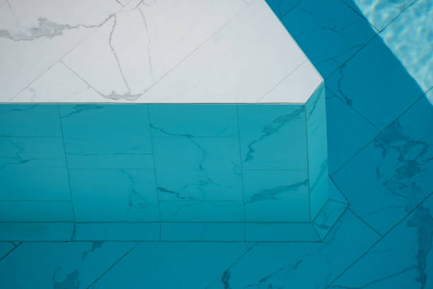 istock Blue ripped water in swimming pool made from white marble stone tile. 1305254710