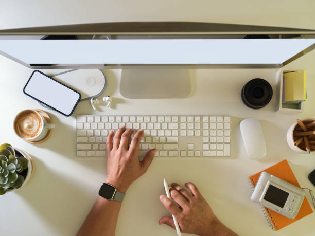 istock Male hand typing on computer keyboard on workspace with smartphone and supplies 1305257059
