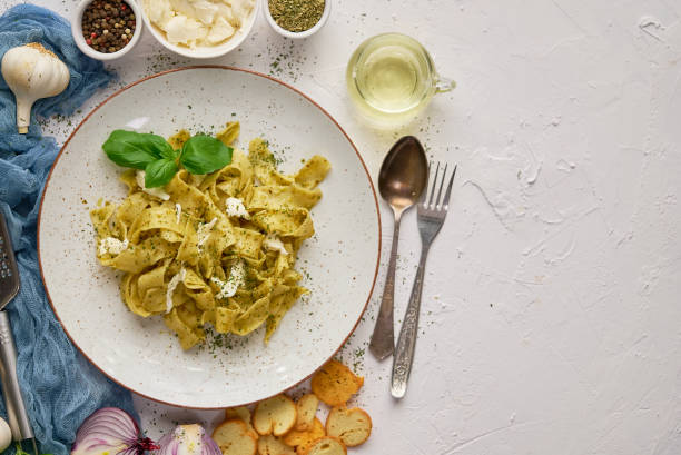 istock Tasty tagliatelle pasta with basil and green pesto 1305258394