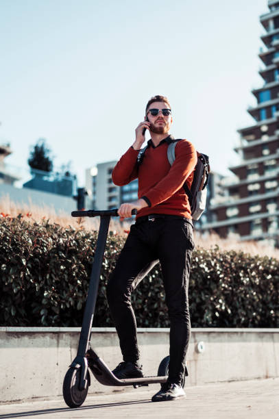 istock Young man riding electric scooter 1305259905