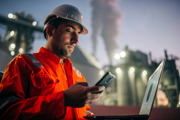 istock Engineer with laptop working in oil refinery 1305262622