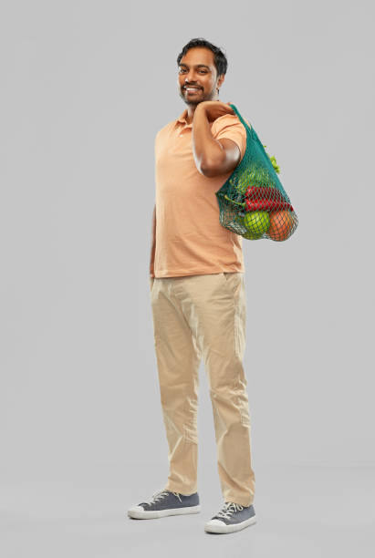 istock happy indian man with food in reusable net tote 1305264149