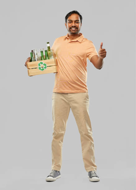 istock smiling young indian man sorting glass waste 1305264274