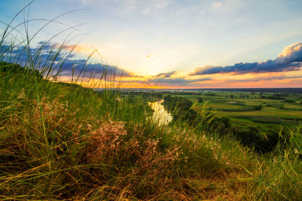 istock A beautiful valley with a river, blue sky with large clouds and bright sun. Aerial 1305265405
