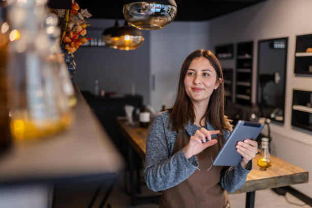 Young perfume store owner checking her stock with notepad
