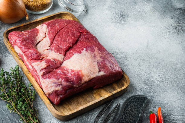 istock Raw Beef belly, beef brisket meat,with ingredients for smoking  making  barbecue, pastrami, cure, on gray stone background,  with copy space for text 1305269169