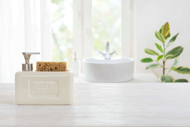 istock Hygienic soap dispenser on table against defocused bathroom sink background 1305269174