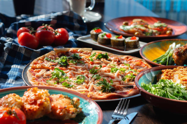 istock Yummy homemade pizza on a buffet table in a beautiful setting, sunny lighting 1305272271