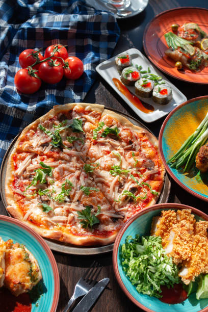 istock Yummy homemade pizza on a buffet table in a beautiful setting, sunny lighting 1305272276