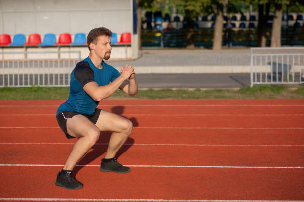 istock Sporty bearded man doing squats 1305272577