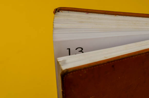 istock Half-opened diary with the number 13 on a worn page. 1305273560