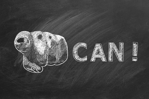 You can. Close up of a human hand pointing at you with lettering CAN. Animation drawn in chalk on blackboard. Business motivational inspirational quotes. Concept of ability, possibility, motivation.