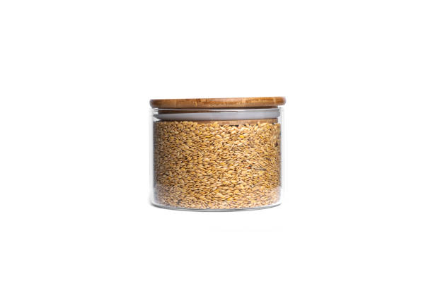 istock Flax seeds in a glass jar isolated on a white background 1305274703