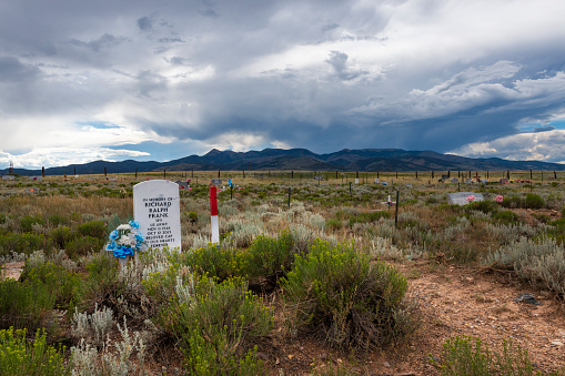 Villa Grove, Colorado - July 13, 2014: View of a cemetery (Villa Grove Veterans Memorial) with mountains on the background, near Villa Grove, in the State of Colorado, USA