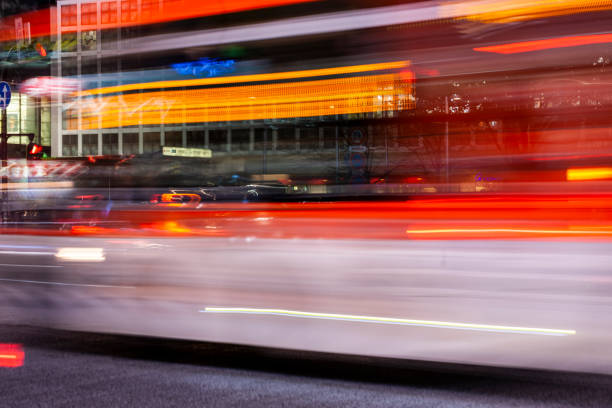 Blue articulated bus driving through a crossing in the city.