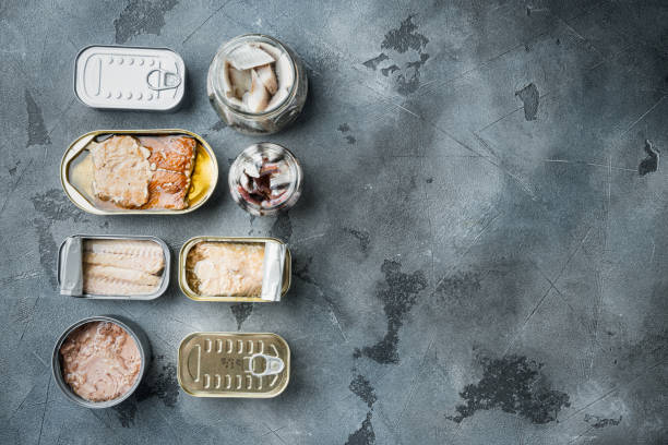 istock Canned fish, top American preserves, on gray background, top view flat lay, with copyspace  and space for text 1305275148