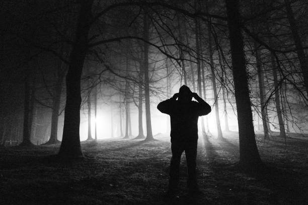 istock Sinister silhouette man lurking in the shadows 1305279156