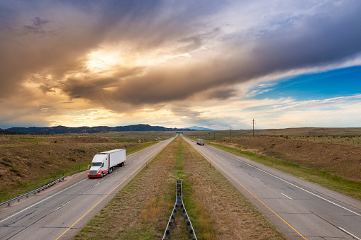 A semi truck at the I 25 interstate highway, in the State of Colorado, USA; Concept for freight transportation.