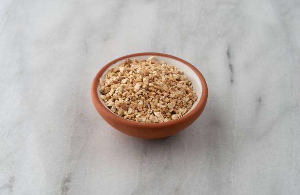 istock Cut orris root in a bowl on a marble counter top 1305279390