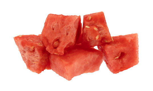 Side view of ripe watermelon chunks isolated on a white background.