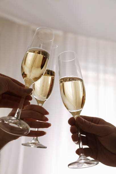 istock People clinking glasses with champagne at home, closeup 1305281987