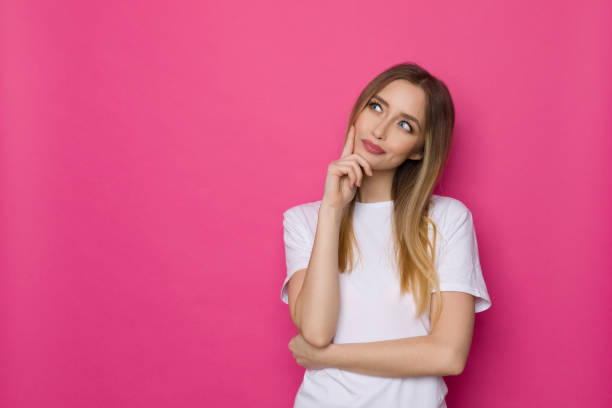 istock Beautiful Young Woman In White Shirt Is Thinking 1305283371