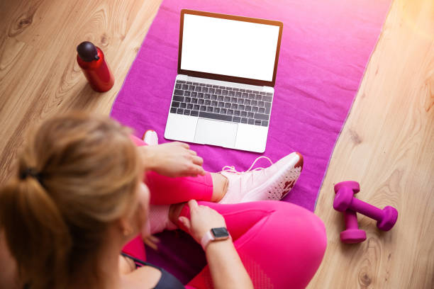istock Woman using laptop during fitness training 1305283513