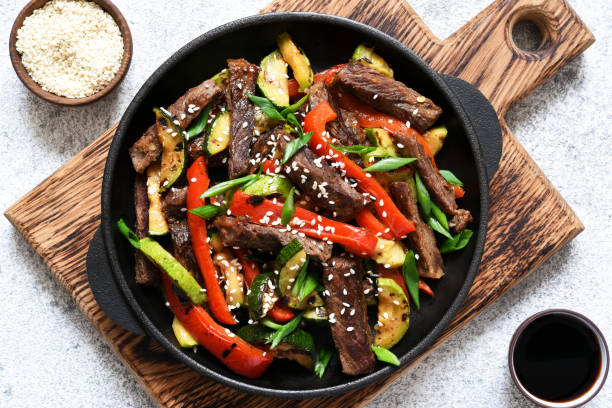 Frying pan with vegetables and beef and sesame seeds. Asian food. stock photo
