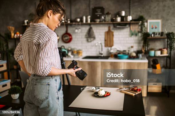 Photographer Woman In Her Studio Stock Photo - Download Image Now - Rear View, Standing, 25-29 Years