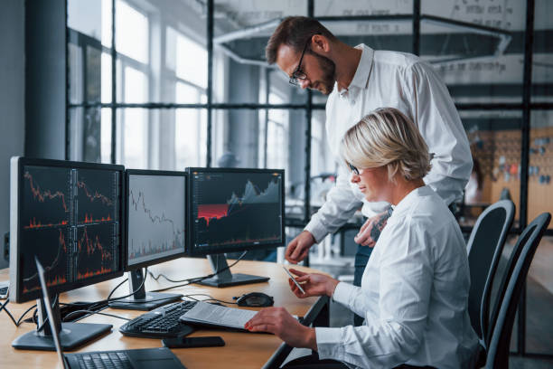 istock Analyzing information together. Two stockbrokers in formal clothes works in the office with financial market 1305286212